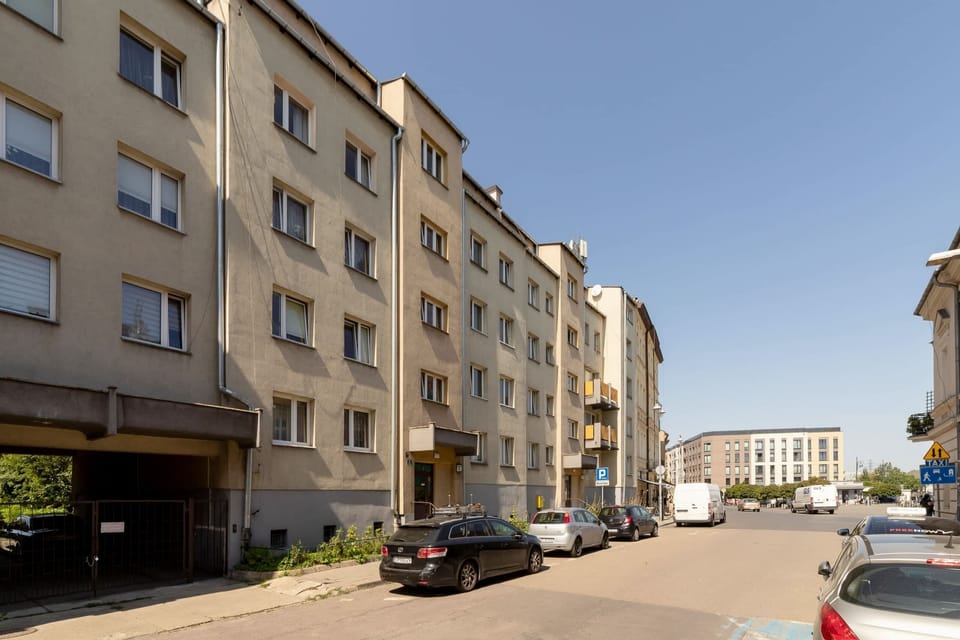 An exterior shot of the apartment building, showcasing the residential area and street view.
