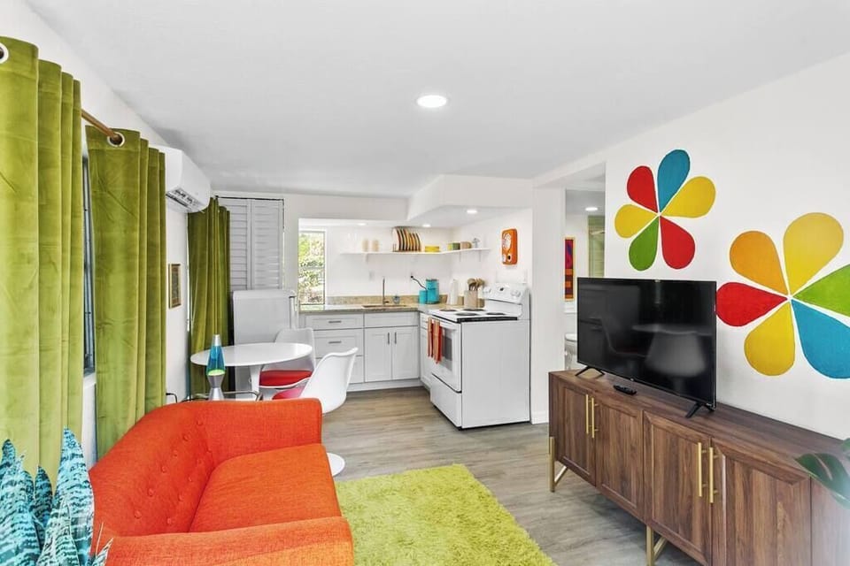 Retro vibes, modern binge. 60-inch smart TV, cozy seating, and a living room made for you