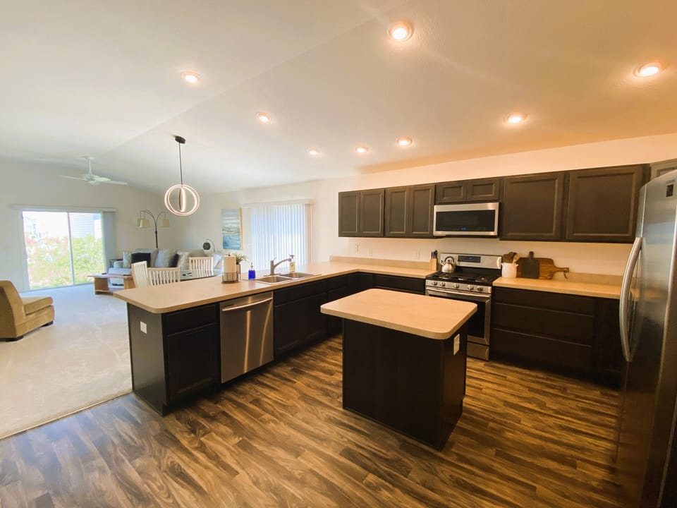 Gourmet kitchen and island with seating along the bar