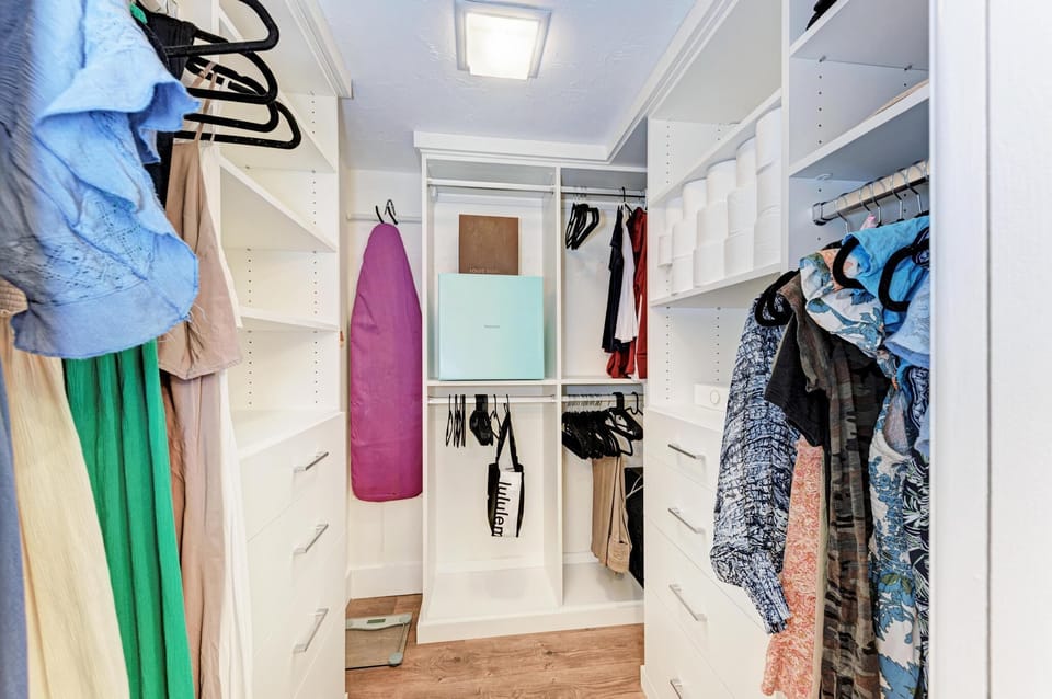 Lots of storage in master closet california closet shelving and drawer space