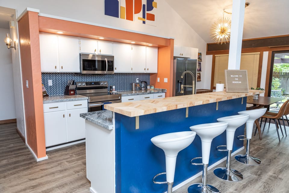 Island bar with chevron butcher block and 4 golf-tee shaped stools