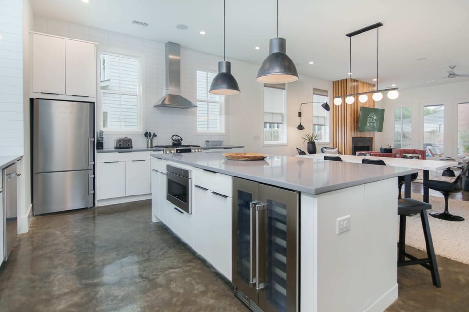 Walk in to an open floor plan, with a modern kitchen, living and dining space.