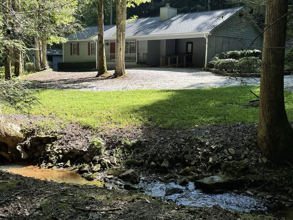Creek front home perfectly nestled amongst hemlocks and hardwoods 