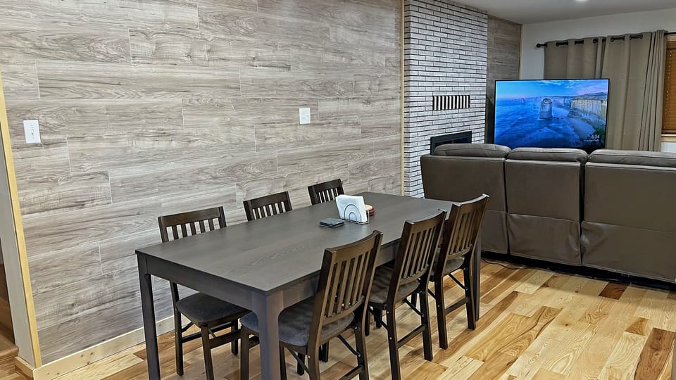 Dining area with table that seats 8 and can extend to accommodate up to 10. 