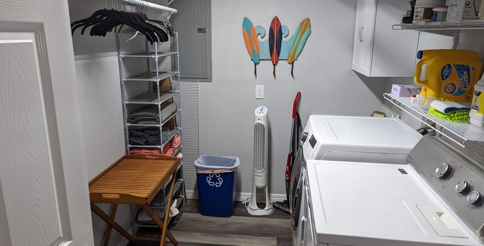 Laundry room showing King bedroom closet and linen storage.