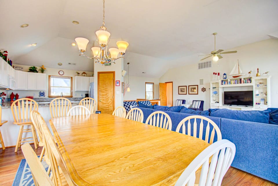 There is seating at the bar for 4 and the adjoining dining area features a large table with seating for 10 and a water view.