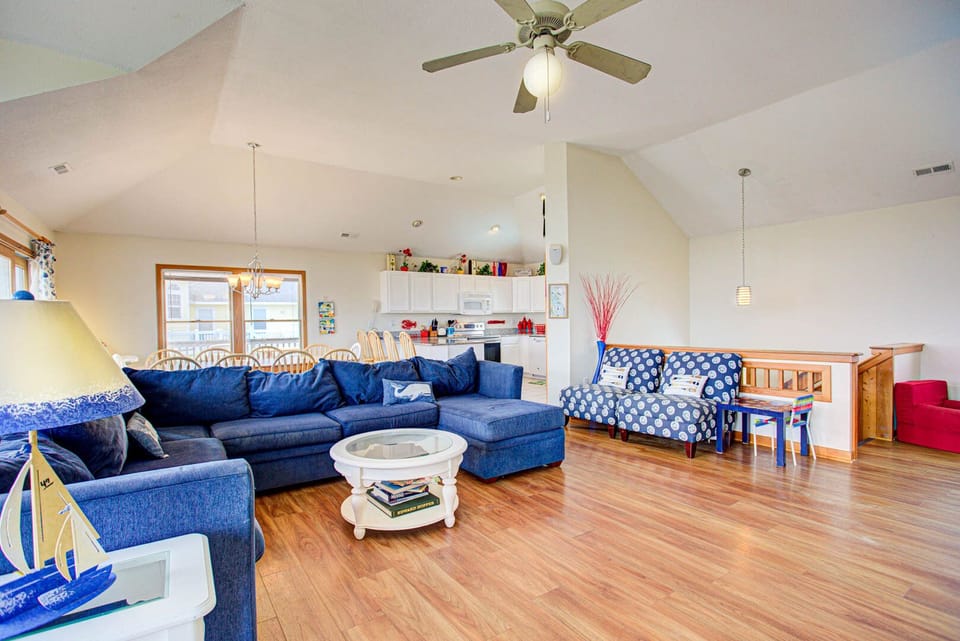 The Living Area features a Flat-Screen TV, high ceilings, and large windows that gaze out over the Atlantic.