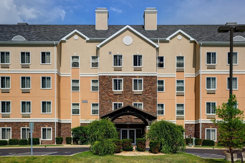 Multi-story hotel exterior with landscaped grounds.