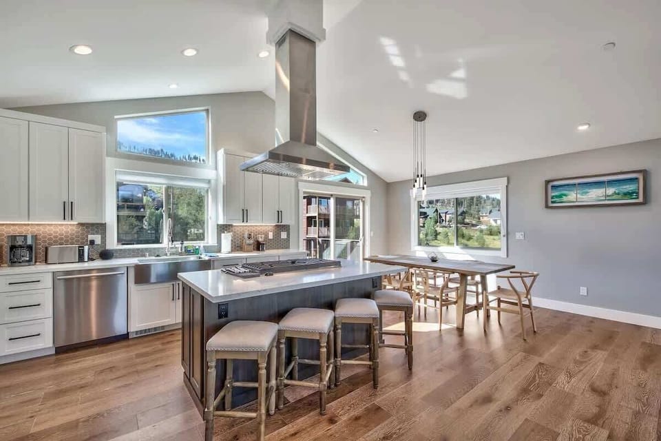 Gas range, with fully equipped kitchen. Stocked with cookware, bakeware, and dinnerware for a holiday meal. 