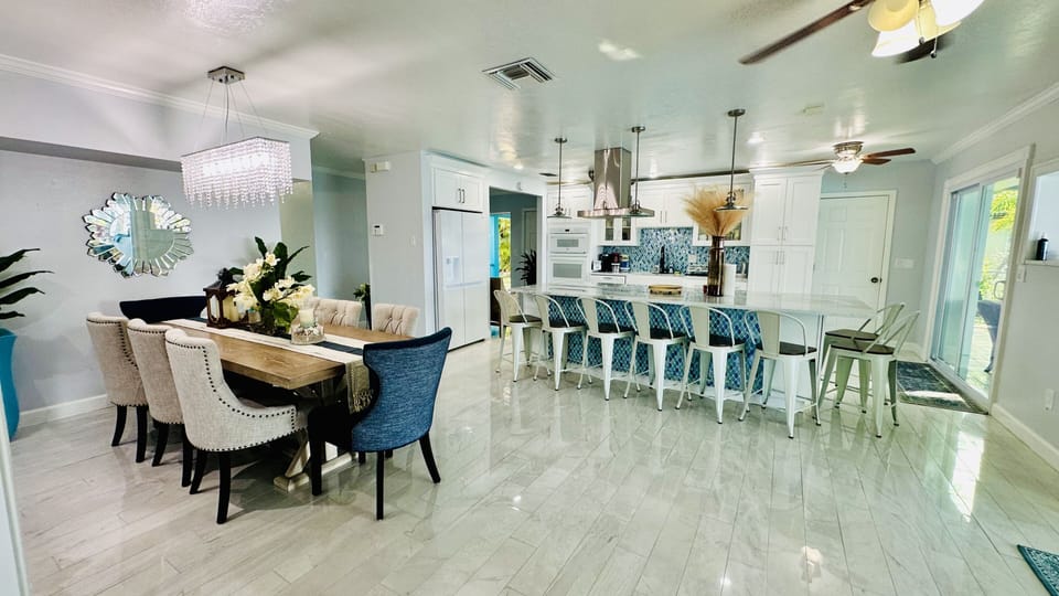 Dining table holds 8 people and kitchen island holds 10 people for a total of 18