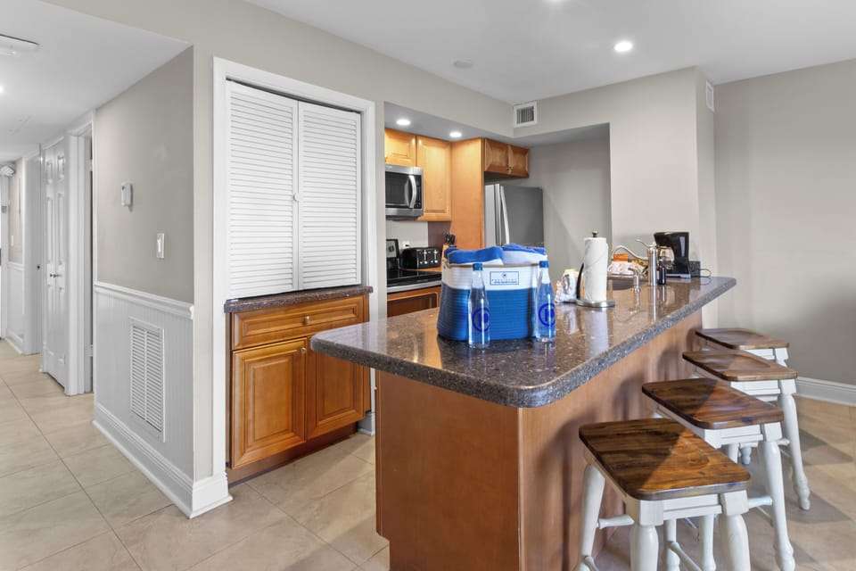 Enjoy easy meals with a roomy kitchen island and bar seating.