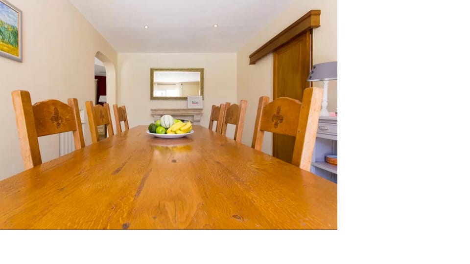 dining room, table seats 8, antique dresser and mirrors