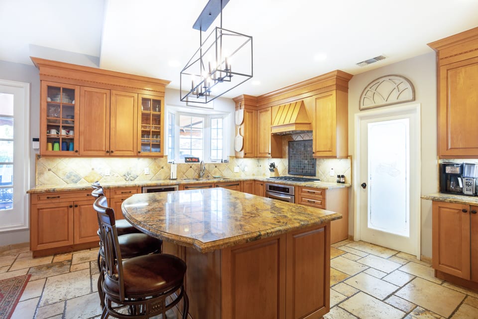 Beautiful and functional kitchen with everything you could need and more! Large island, wine fridge, dishwasher, stove, and so much more!