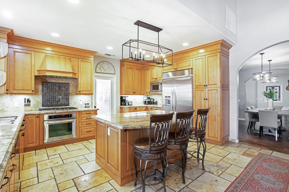 Beautiful and functional kitchen with everything you could need and more! Large island, wine fridge, dishwasher, stove, and so much more!