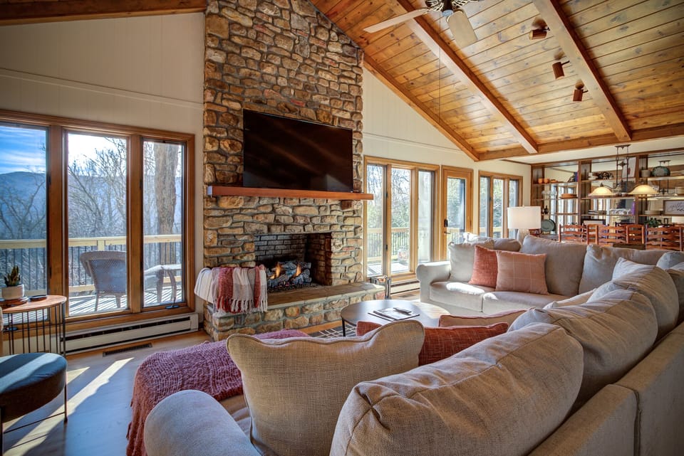 Living room with a gas fireplace, large couch and a smart TV!