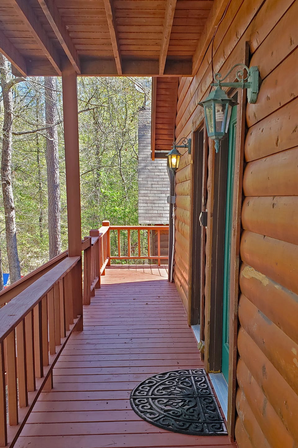 Back deck with stairs leading to hot tub