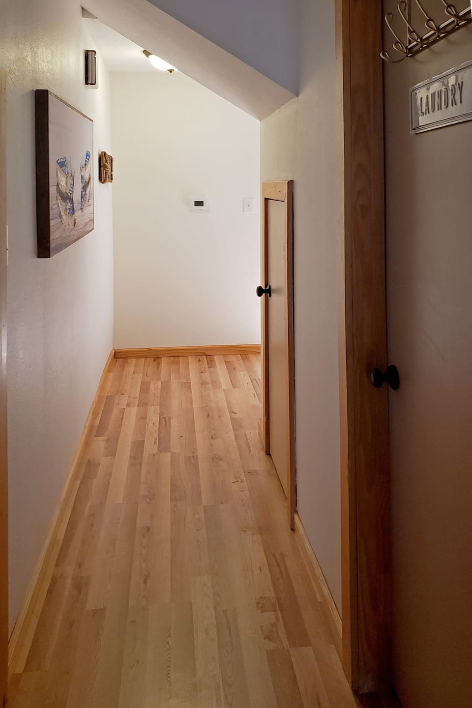 Hallway leading to laundry room and two bedrooms downstairs