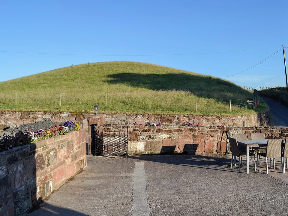 Quiet seating area in the courtyard right outside the living area | Liftingstane Dairy Cottage - Liftingstane, Closeburn, near Thornhill