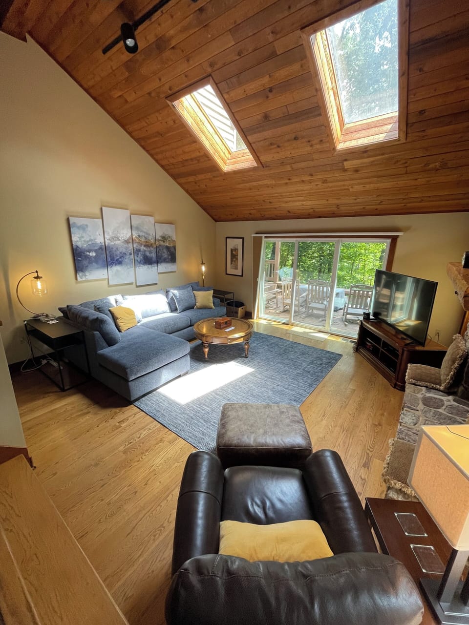 Open family room with vaulted ceilings, sky lights provide lots of natural light