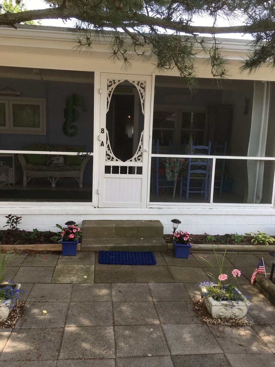 Charming front door leads to screened in porch