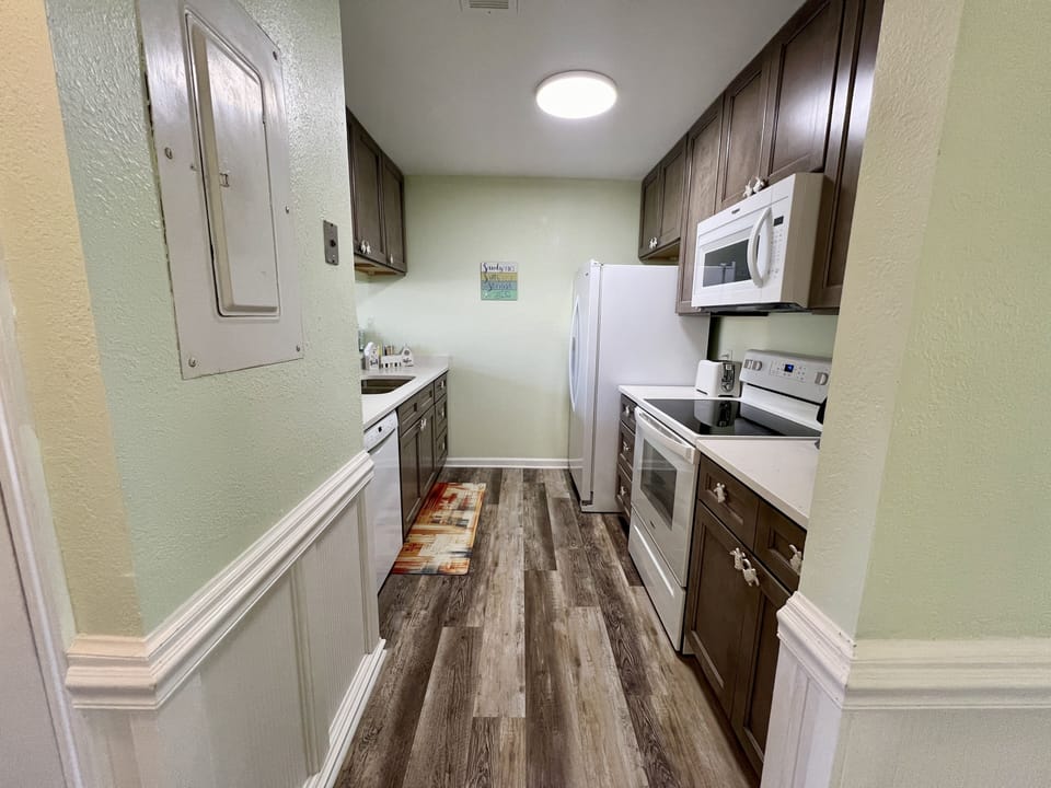 The galley kitchen is fully stocked with everything that you'll need.