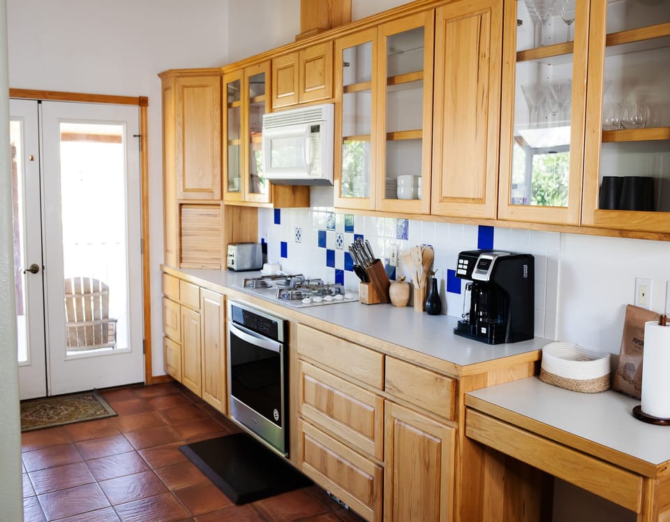 Spacious kitchen with basic appliances and essentials.