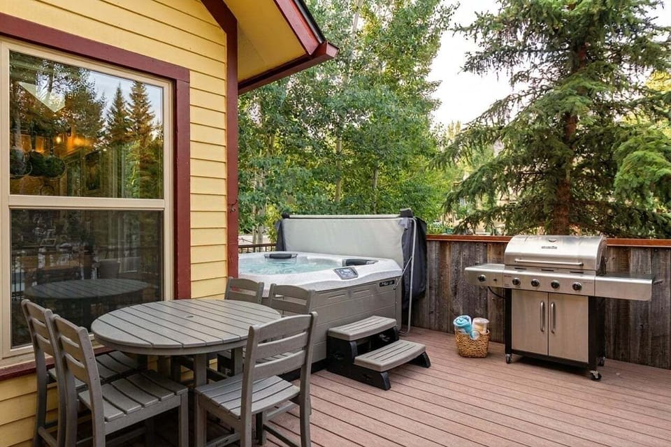 Private Outdoor Living - Enjoy the hot tub, outdoor dining, BBQ grill, and beautiful views toward Breckenridge Ski Resort.
