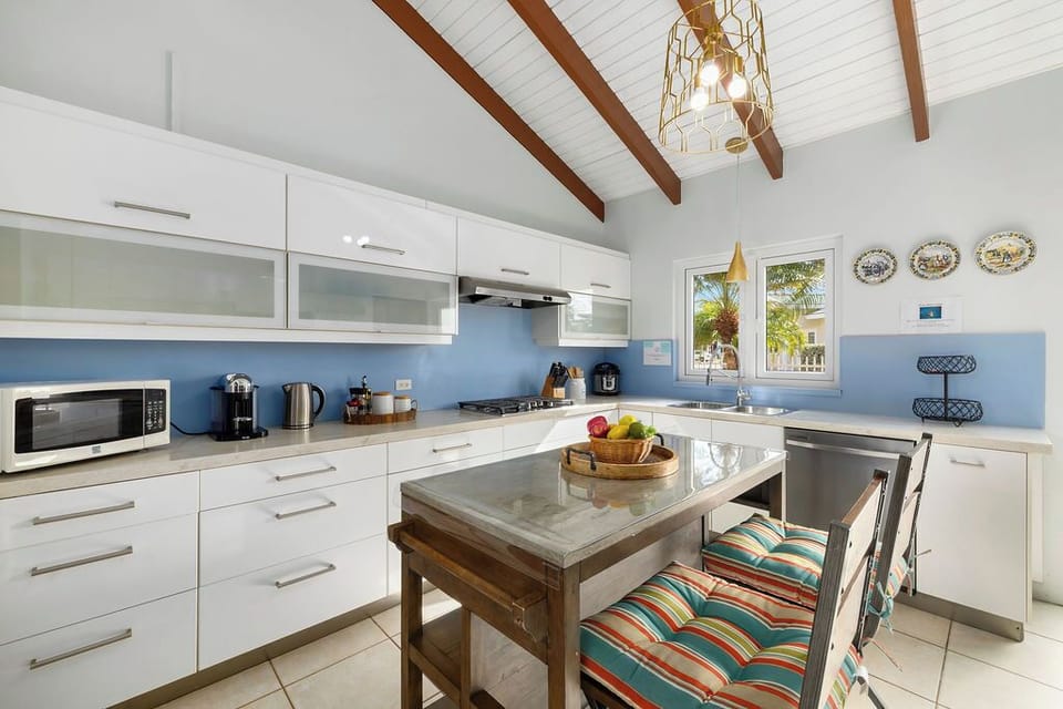 Pull up a seat! Our vibrant kitchen island is the perfect spot for your morning coffee, a quick lunch, or evening cocktails. Casual dining meets island charm!