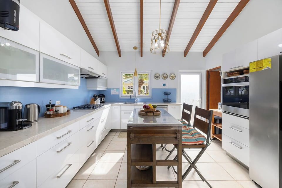 Enjoy the convenience of a fully equipped kitchen featuring sleek stainless-steel appliances, a built-in oven, and a spacious island for prepping and gathering. Everything you need to feast in style.
