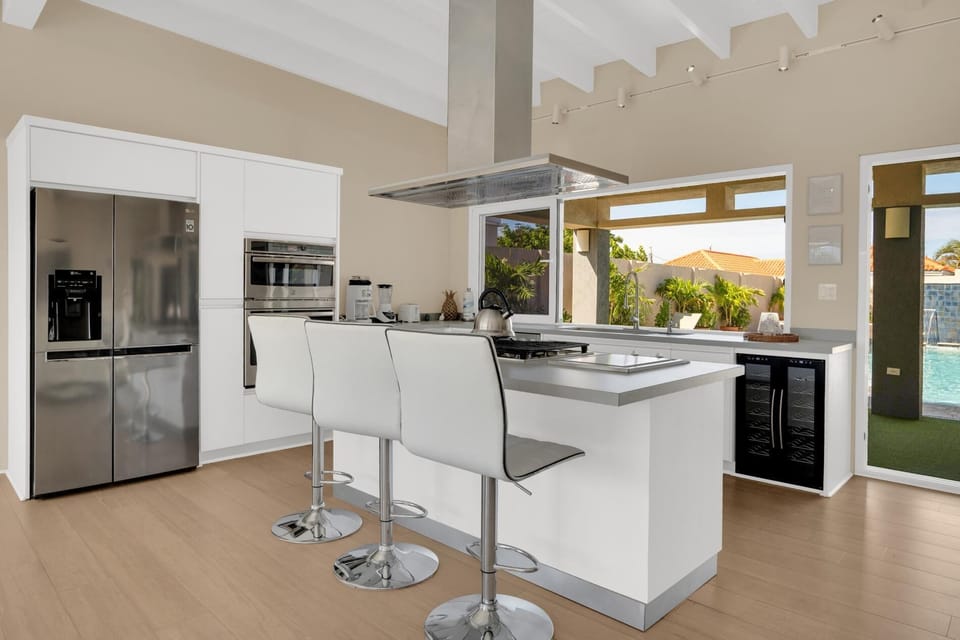 The modern full-size kitchen comes fully equipped with pristine granite countertops.
