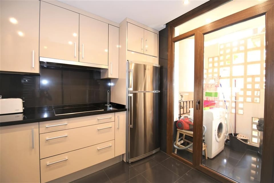 Another view of the kitchen with laundry room to the rear