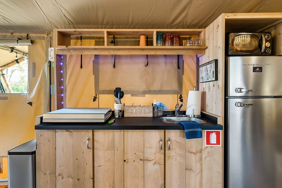 An apartment sized fridge with a microwave.