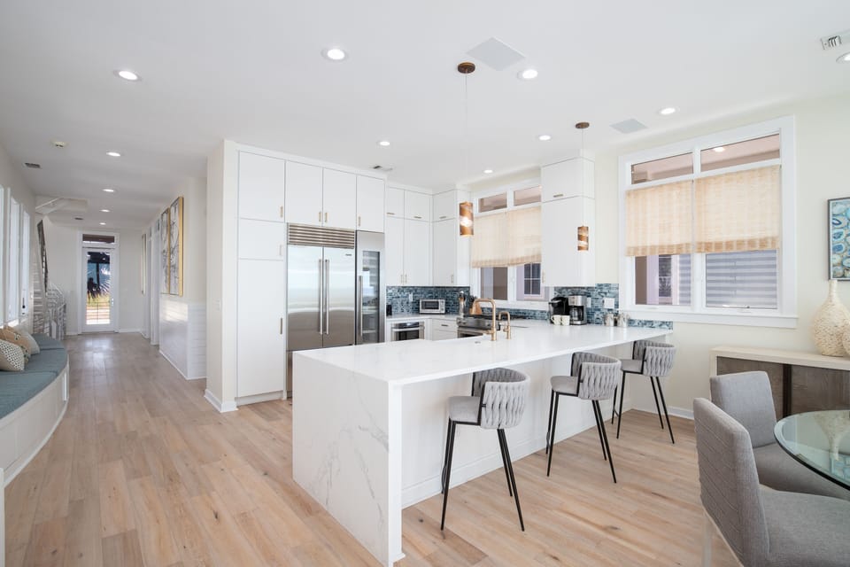 The kitchen island with three bar stools is the ultimate gathering spot, sip your morning coffee, catch up with family, or keep the chef company while dinner comes together.