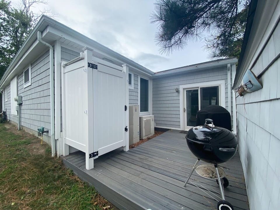 Outdoor shower and deck with both a gas (Fuego) grill and a Weber charcoal grill