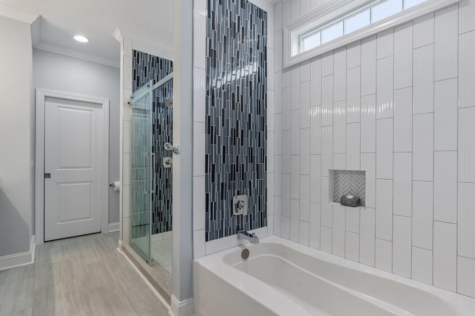 Our completely renovated master bathroom features a tub and a shower, double vanity and a walk in closet.