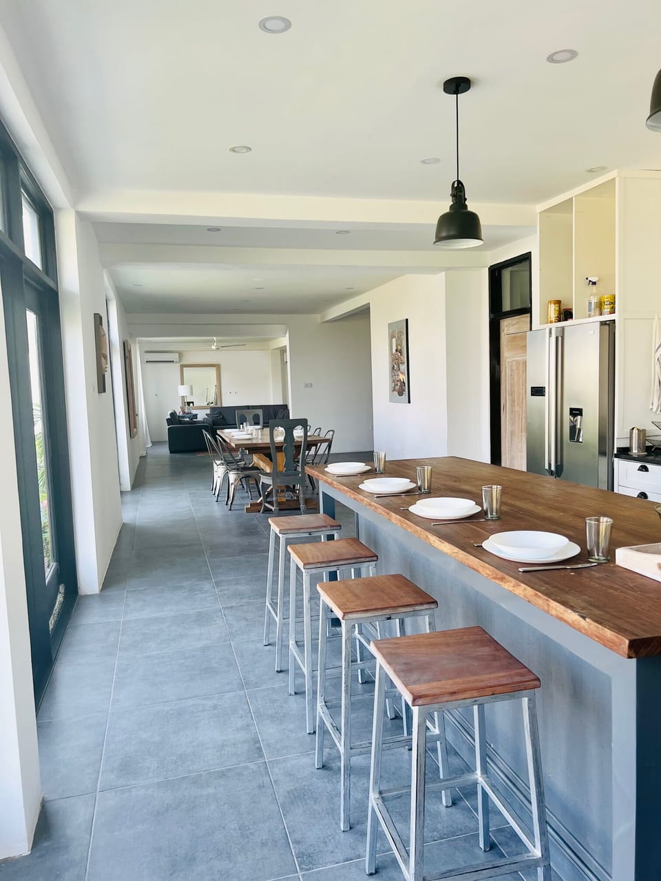The kitchen includes a large island with additional seating for four. 