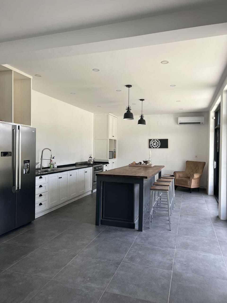 The dining area leads to the kitchen w/ fridge/freezer, oven/stove, & microwave.