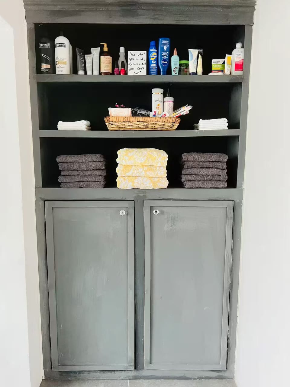 Guest linen closet includes extra towels and supplies.