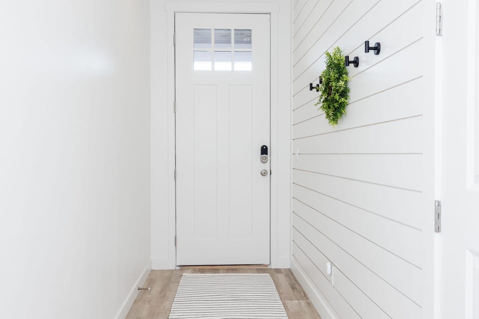 Beautiful entryway with space to hand coats, jackets, etc.