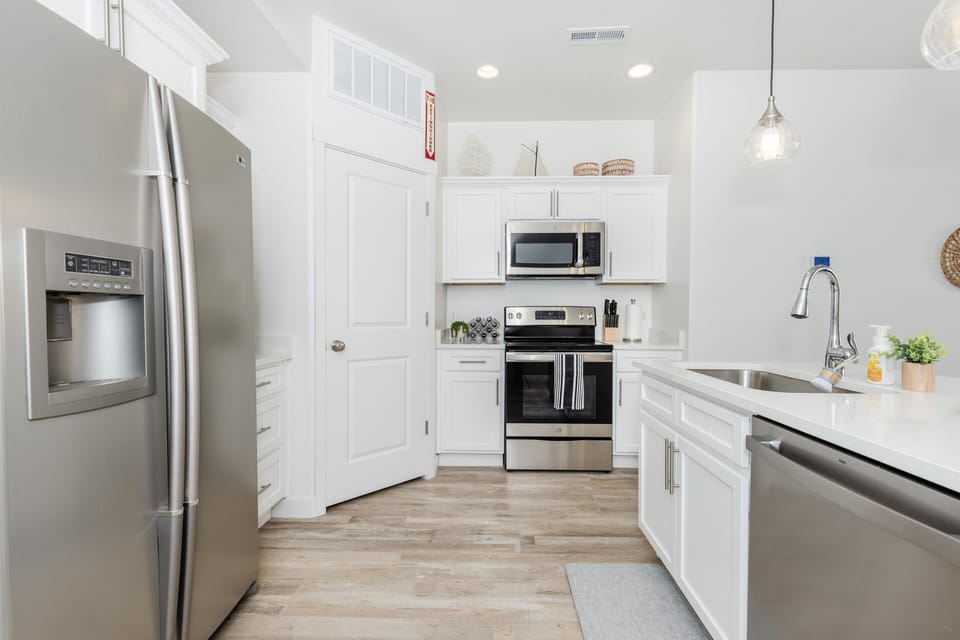 Main-level kitchen and dining room off back patio. Seats 9.