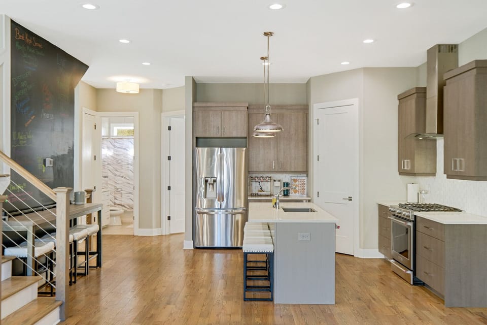 Kitchen with island, bar, and chalkboard wall