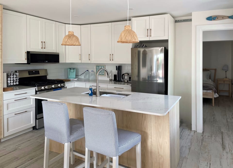 Kitchen (stainless steel stove, microwave, dishwasher, and fridge/freezer).