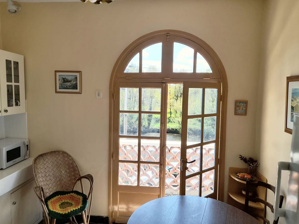 Kitchen door opens onto balcony overlooking the river.