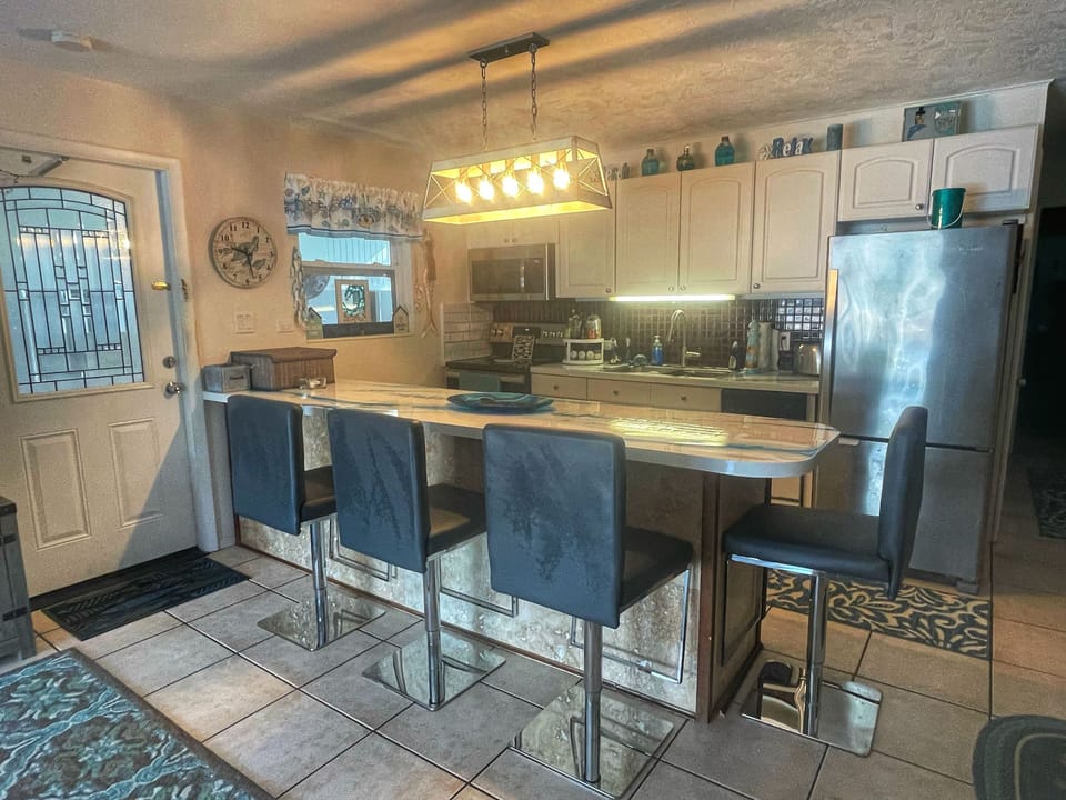 Fully Stocked Kitchen With Bar Top Dining