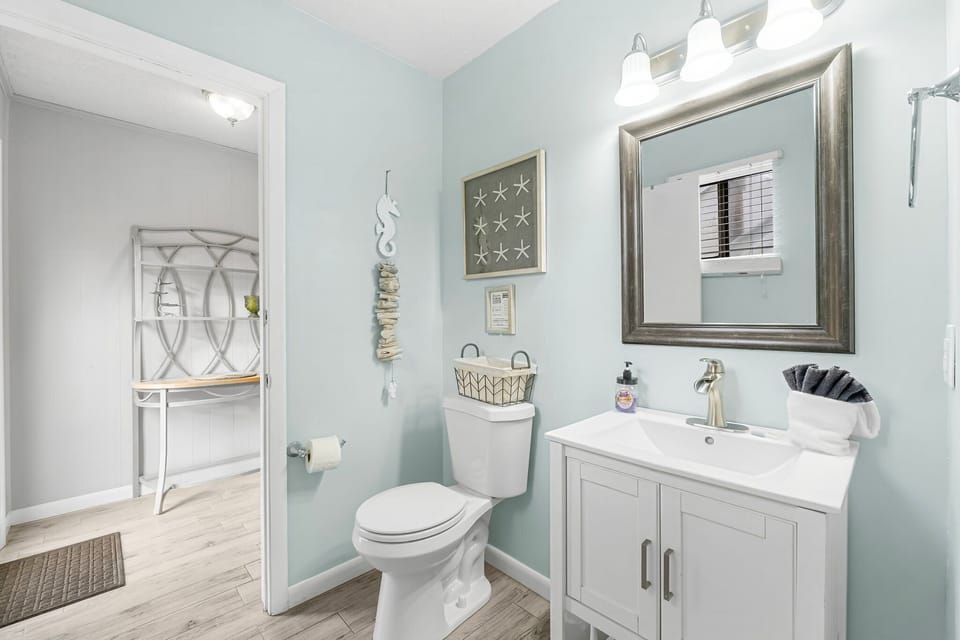 Downstairs Half Bathroom attached to laundry room w/ access to backyard and carport