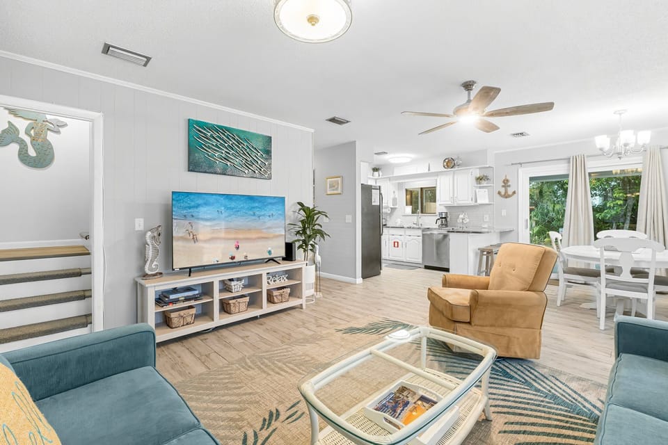 Comfortable living room with plenty of seating and large smart TV — perfect for relaxing after beach days.
