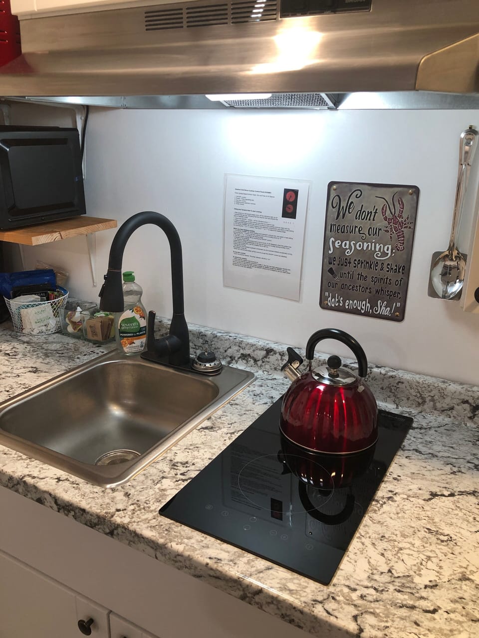 Kitchen sink and cooktop. Kettle for teas and whatnot. 