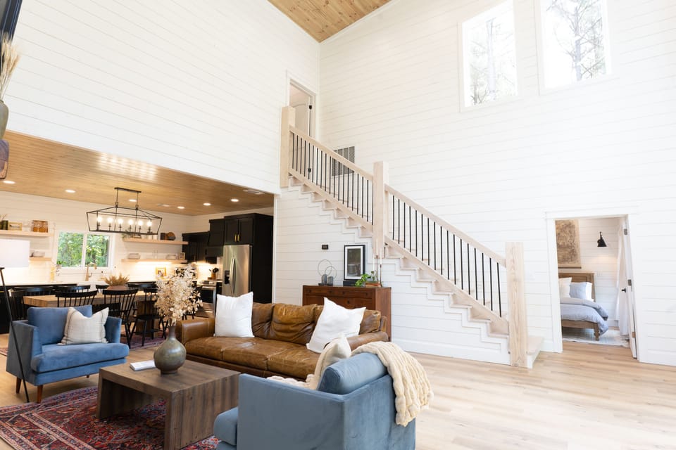 Enter the cabin to a communal, open, airy, bright space with a 2 story stone fireplace and comfortable seating