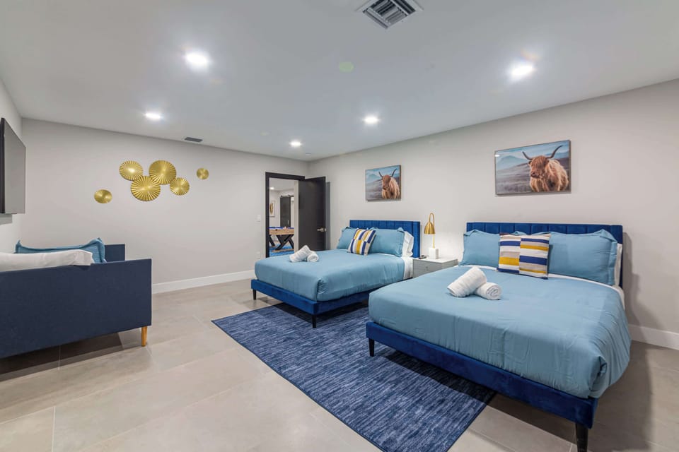 Spacious bedroom featuring two queen-size beds and one twin bed, ideal for families or groups traveling together. Thoughtfully designed for comfort and functionality, with cozy linens and stylish decor.