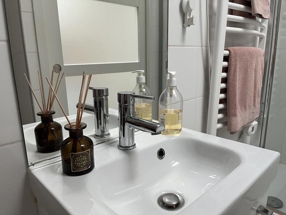 wash basin and heated towel rack in shower and toilet room
